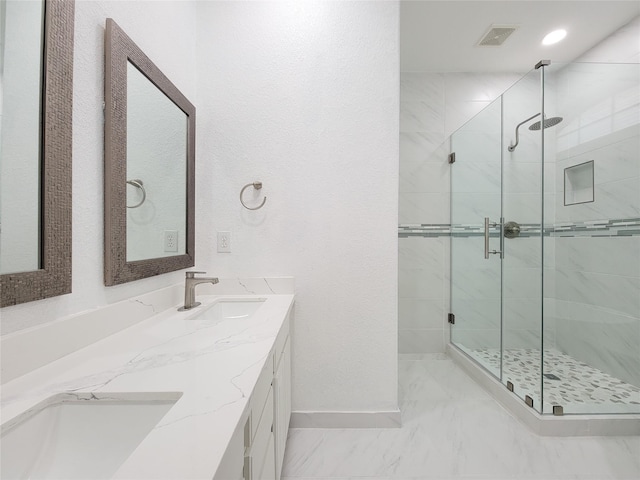 bathroom featuring vanity and an enclosed shower