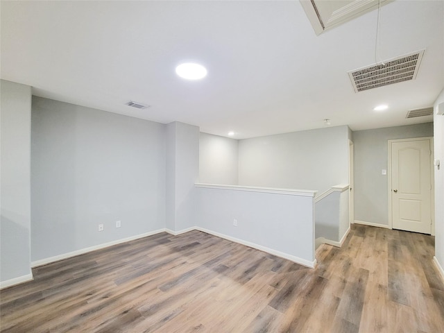 basement with hardwood / wood-style flooring