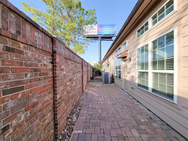 view of patio featuring fence and central air condition unit