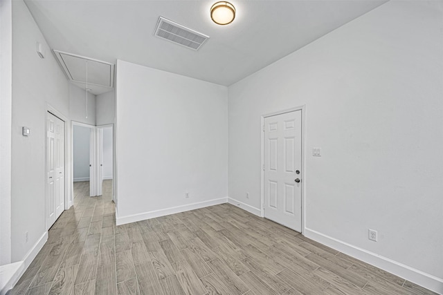 unfurnished room with light hardwood / wood-style floors