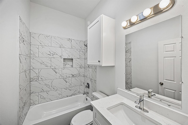 full bathroom featuring vanity, tiled shower / bath combo, and toilet