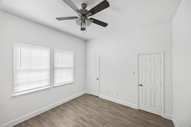 spare room with hardwood / wood-style floors and ceiling fan