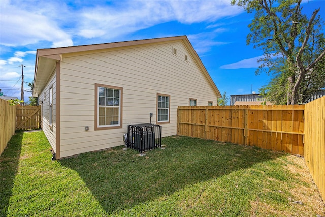 rear view of house with a yard and cooling unit