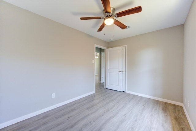 spare room featuring ceiling fan and light wood-type flooring