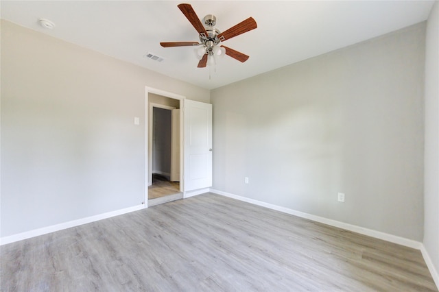 empty room featuring ceiling fan and light wood-type flooring