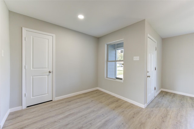 spare room featuring light wood-type flooring