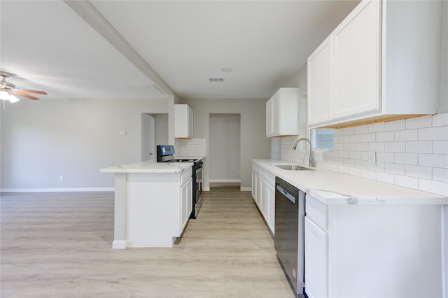 kitchen featuring sink, white cabinetry, tasteful backsplash, kitchen peninsula, and black appliances