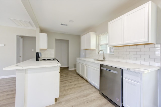 kitchen with dishwasher, stove, sink, and white cabinets