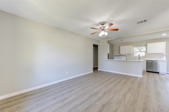 unfurnished living room featuring sink, light hardwood / wood-style floors, and ceiling fan