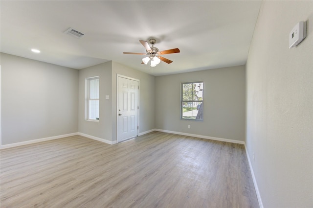 spare room featuring ceiling fan and light hardwood / wood-style floors