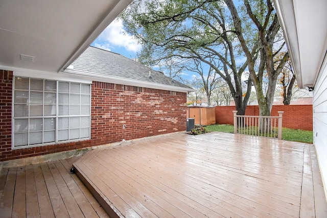 wooden deck featuring central AC unit