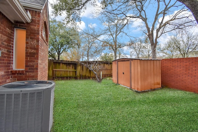 view of yard featuring a storage unit and central AC unit