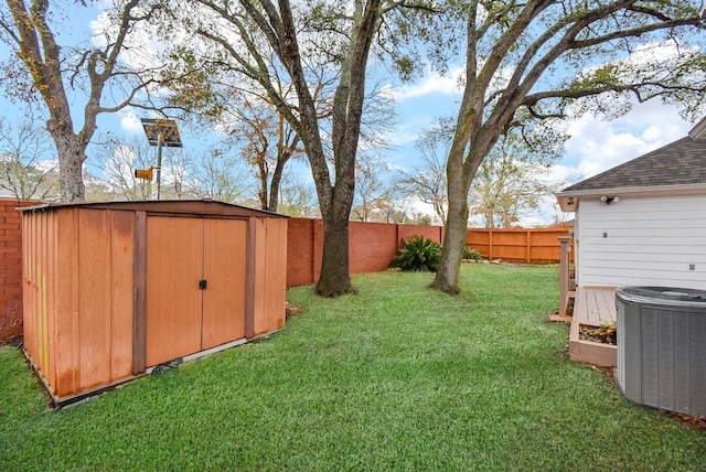 view of yard with cooling unit and a storage unit