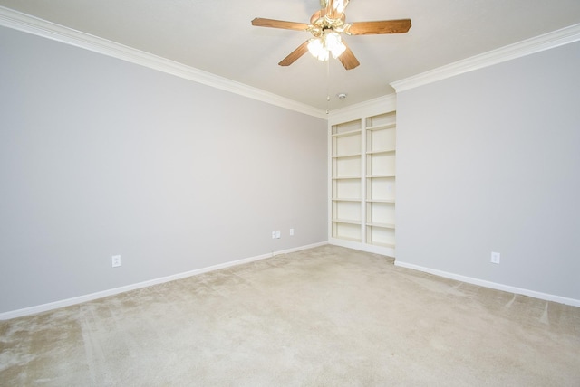 carpeted spare room featuring crown molding and ceiling fan