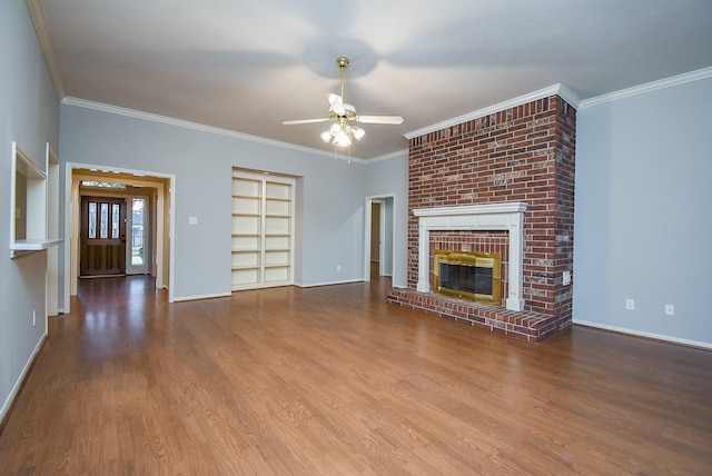 unfurnished living room with ceiling fan, ornamental molding, a fireplace, and hardwood / wood-style floors