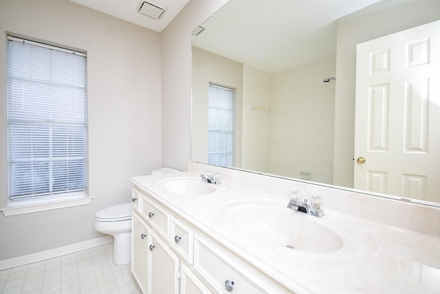 bathroom with vanity, tile patterned flooring, and toilet