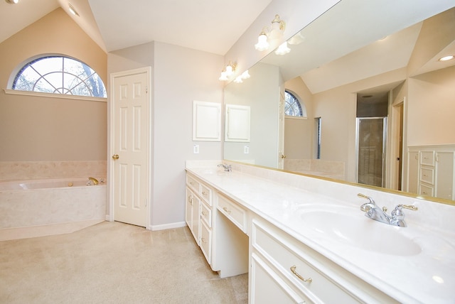 bathroom featuring vaulted ceiling, shower with separate bathtub, a wealth of natural light, and vanity