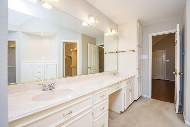 bathroom featuring vanity and vaulted ceiling