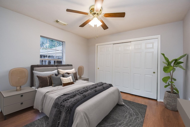 bedroom featuring dark hardwood / wood-style flooring, a closet, and ceiling fan