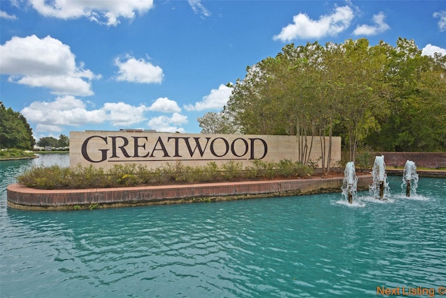 community / neighborhood sign featuring a water view