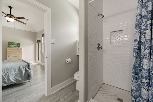 bathroom featuring hardwood / wood-style flooring, toilet, ceiling fan, and a shower with curtain