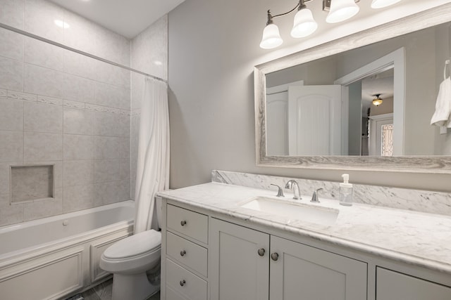 full bathroom featuring shower / bath combo, vanity, and toilet