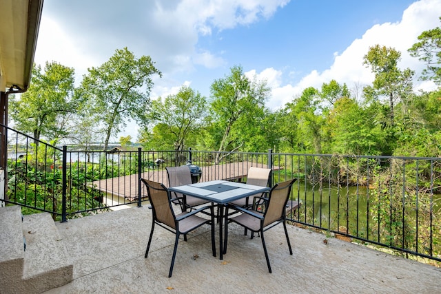 view of patio with a balcony and a water view