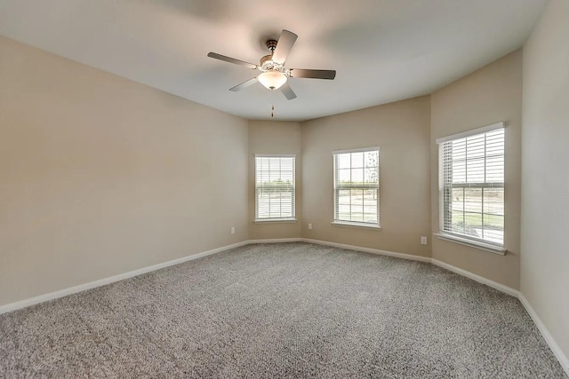 carpeted empty room featuring ceiling fan