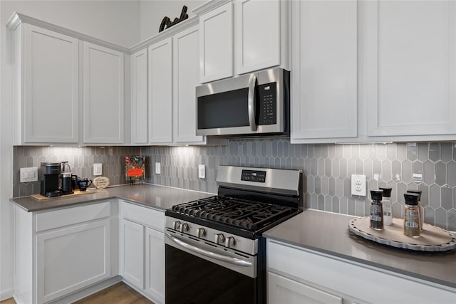 kitchen featuring backsplash, stainless steel appliances, light hardwood / wood-style flooring, and white cabinets