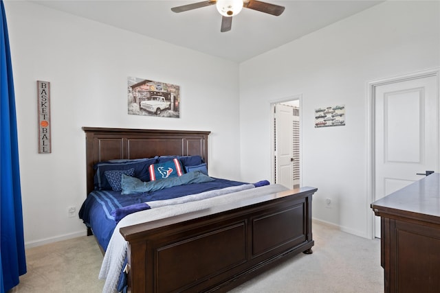 bedroom featuring light colored carpet and ceiling fan