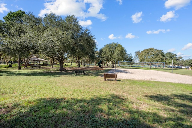 surrounding community with a gazebo, a lawn, and volleyball court