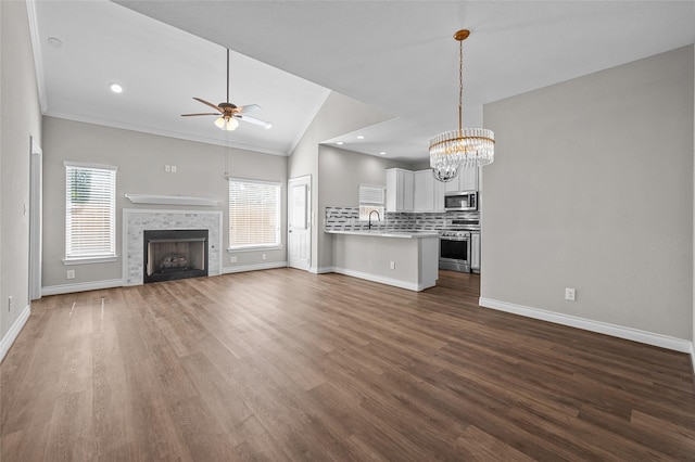 unfurnished living room featuring a wealth of natural light, a fireplace, and dark wood-type flooring