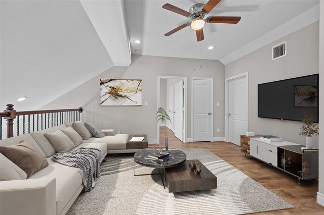 living room with ceiling fan, lofted ceiling, and wood-type flooring