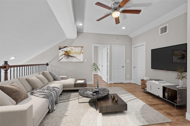 living room with lofted ceiling, hardwood / wood-style floors, and ceiling fan