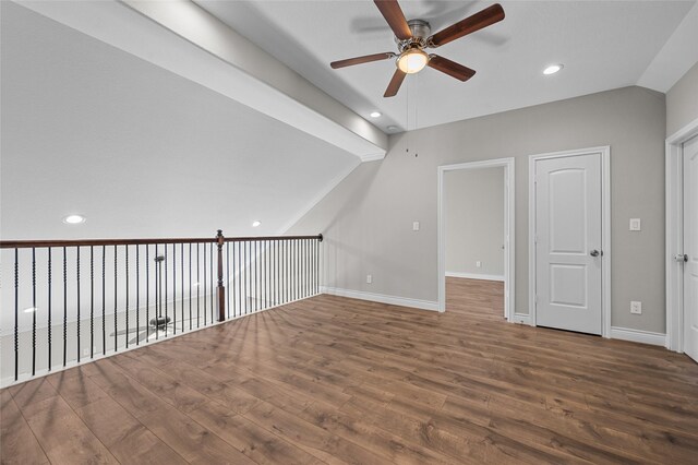 additional living space with hardwood / wood-style flooring, ceiling fan, and vaulted ceiling