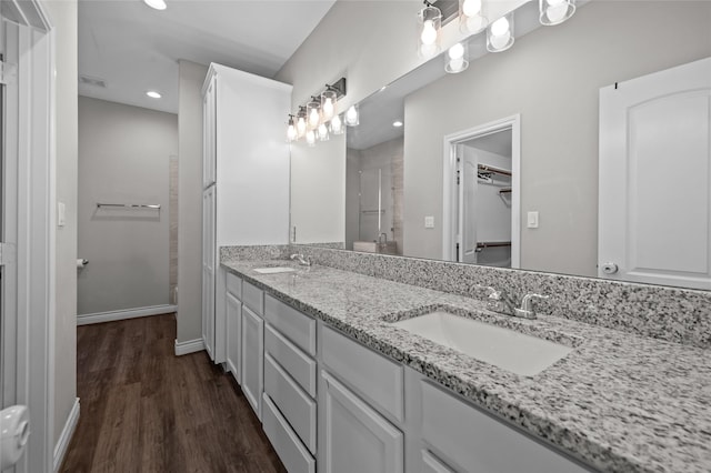 bathroom with vanity, hardwood / wood-style floors, and walk in shower