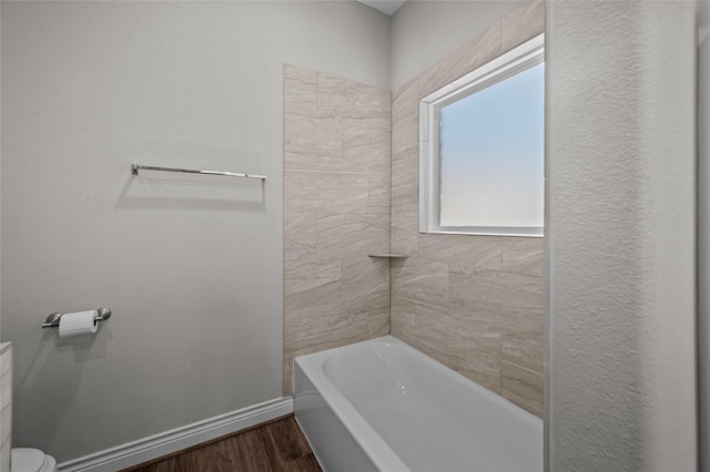 bathroom featuring hardwood / wood-style floors and toilet