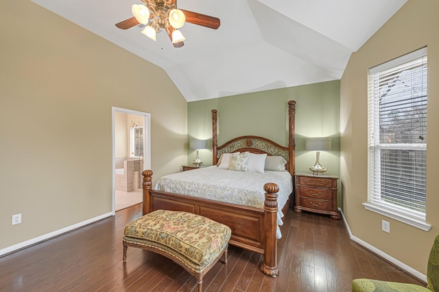 bedroom featuring dark wood-type flooring, vaulted ceiling, ceiling fan, and ensuite bathroom