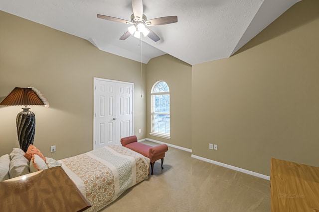 carpeted bedroom featuring ceiling fan, vaulted ceiling, a closet, and a textured ceiling