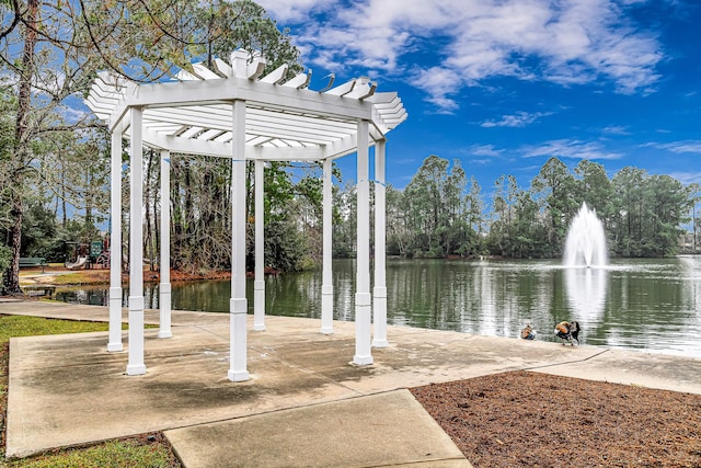 exterior space with a water view and a pergola