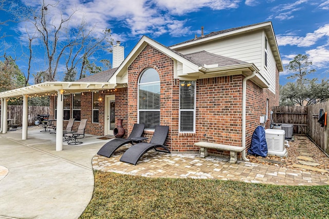 rear view of property featuring central AC unit and a patio