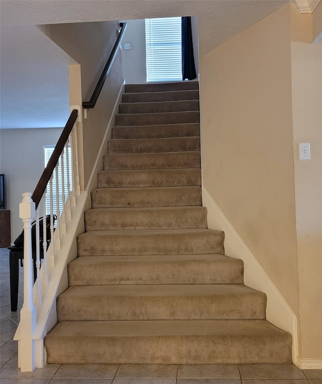 staircase with tile patterned floors