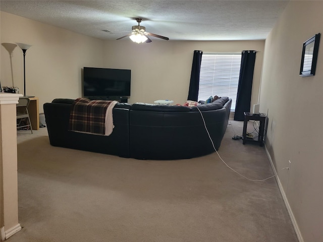 carpeted living room with ceiling fan and a textured ceiling