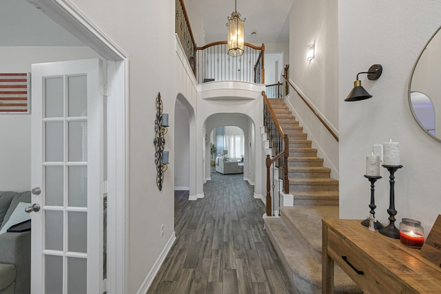 entrance foyer featuring dark hardwood / wood-style floors and a high ceiling