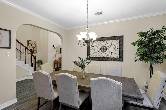 dining room with ornamental molding, a chandelier, and dark hardwood / wood-style flooring