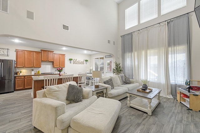 living room featuring a towering ceiling