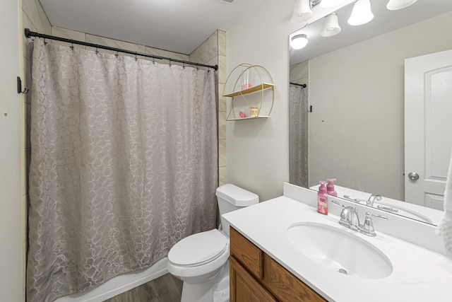 bathroom featuring vanity, wood-type flooring, and toilet