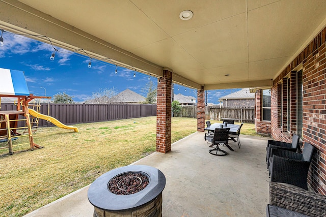 view of patio / terrace featuring a fire pit and a playground