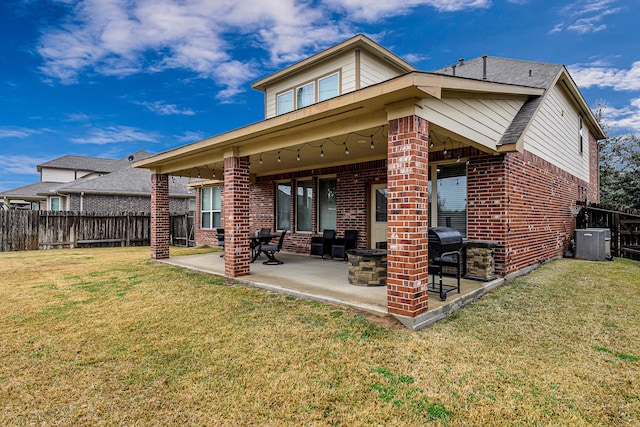 rear view of house featuring a yard, a patio area, and central AC