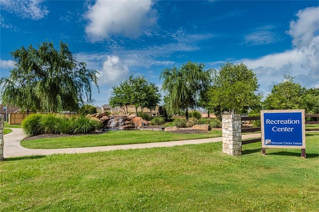 view of property's community with a yard